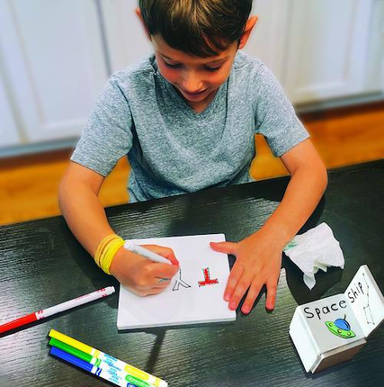 Child Playing with Doodle Tiles at Kitchen Table